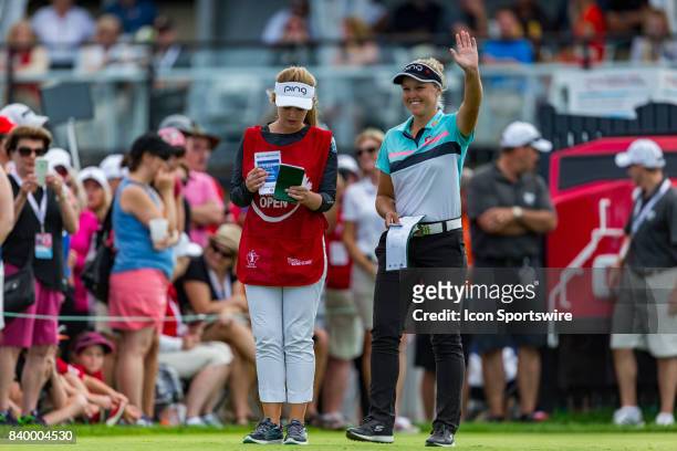 Brooke Henderson waves to the cheering crowd at the 15th hole during the final round of the Canadian Pacific Women's Open on August 27, 2017 at The...