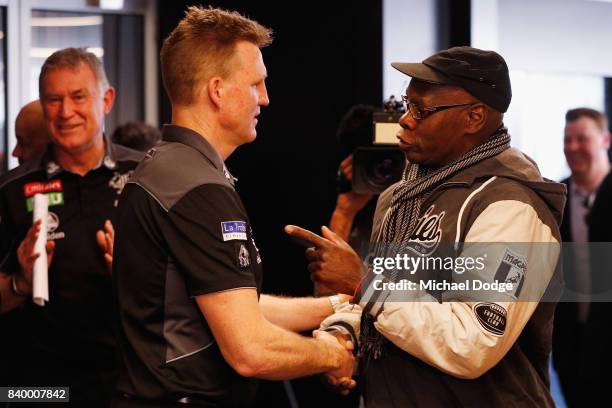 Magpies head coach Nathan Buckley listens to a Magpie fan after a Collingwood Magpies AFL press conference at the Holden Centre on August 28, 2017 in...