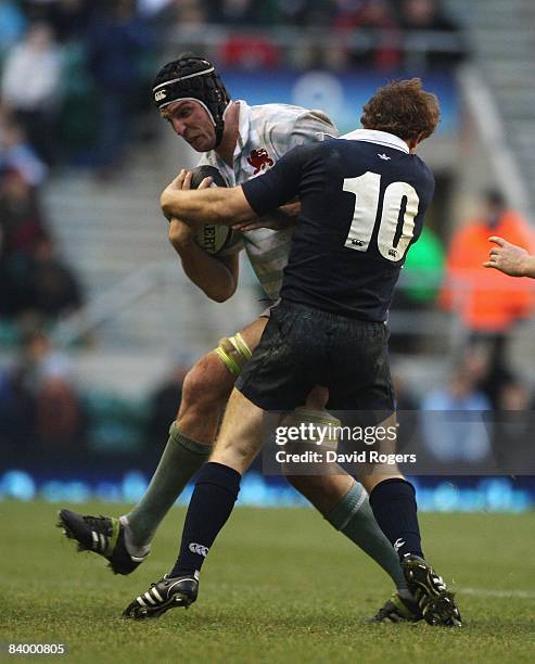 Dan Vickerman of Cambridge is tackled by Ross Swanson during the Varsity match between Oxford University and Cambridge University at Twickenham on...