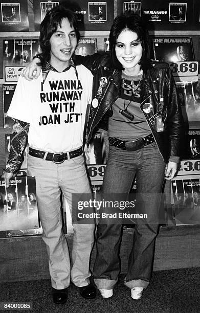 Joan Jett of The Runaways and a fan at an in store appearance at Tower Records in Los Angeles, California. **EXCLUSIVE**