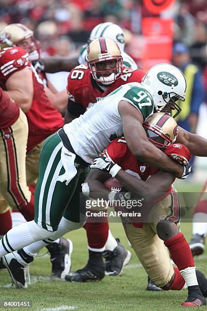 Defensive Tackle Kris Jenkins of the New York Jets stops Running Back Frank Gore of the San Francisco 49ers on December 7, 2008 at Candlestick Park,...