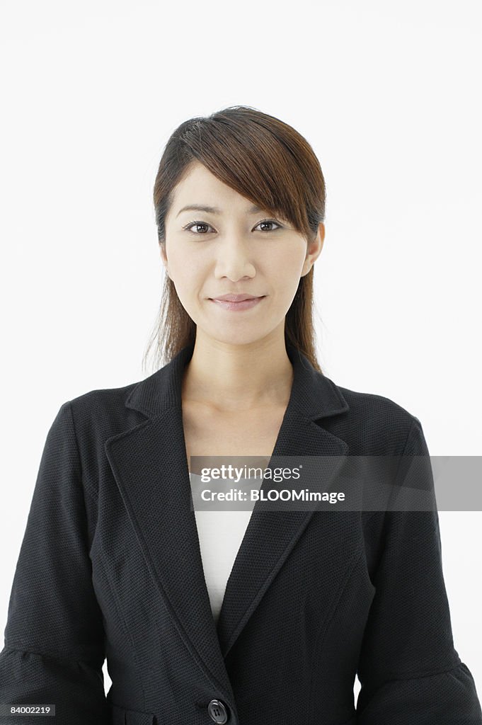 Portrait of businesswoman, close-up, studio shot