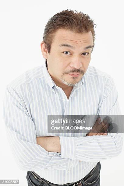 portrait of man with arms folded, close-up, studio shot - portrait close up loosely stock pictures, royalty-free photos & images