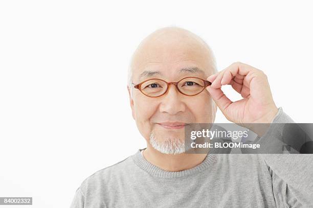 portrait of senior man with glasses, close-up, studio shot - portrait close up loosely stock pictures, royalty-free photos & images