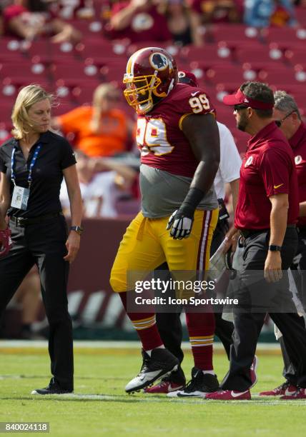 Washington Redskins defensive lineman Phil Taylor, Sr. Is escorted off the field after injuring his leg during the NFL preseason game between the...