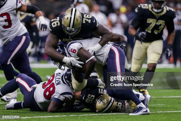 New Orleans Saints defensive tackle Tony McDaniel tackles Houston Texans running back Jordan Todman during the game between the New Orleans Saints...