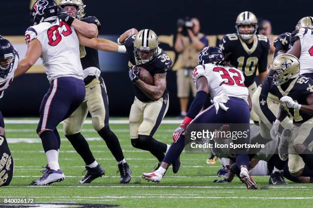 New Orleans Saints running back Daniel Lasco is tackled by Houston Texans defensive back Dee Virgin during the game between the New Orleans Saints...