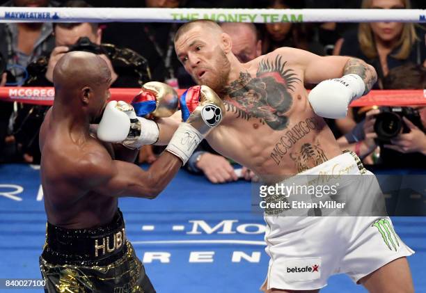 Conor McGregor throws a right at Floyd Mayweather Jr. In the second round of their super welterweight boxing match at T-Mobile Arena on August 26,...