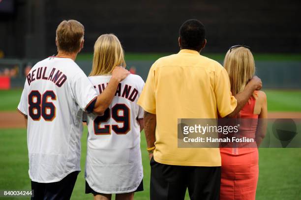 Mary and Ralf Reuland, parents of the late Konrad Reuland, stand with Hall of Fame player Rod Carew and his wife, Rhonda, before the game between the...