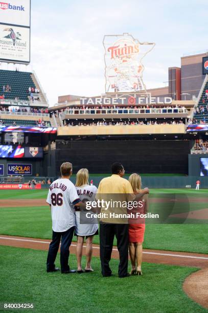 Mary and Ralf Reuland, parents of the late Konrad Reuland, stand with Hall of Fame player Rod Carew and his wife, Rhonda, before the game between the...