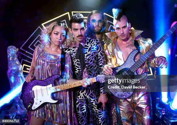 JinJoo Lee, Joe Jonas, Jack Lawless and Cole Whittle of DNCE perform during a pre-taping for the 2017 MTV Video Music Awards at the Palms Casino...