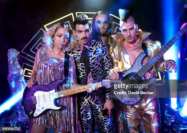 JinJoo Lee, Joe Jonas, Jack Lawless and Cole Whittle of DNCE perform during a pre-taping for the 2017 MTV Video Music Awards at the Palms Casino...
