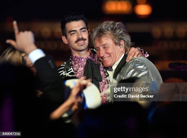 Singers Joe Jonas of DNCE and Sir Rod Stewart perform during a pre-taping for the 2017 MTV Video Music Awards at the Palms Casino Resort on August...