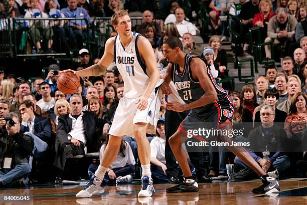 Dirk Nowitzki of the Dallas Mavericks backs down against Alexis Ajinca of the Charlotte Bobcats at the American Airlines Center December 11, 2008 in...