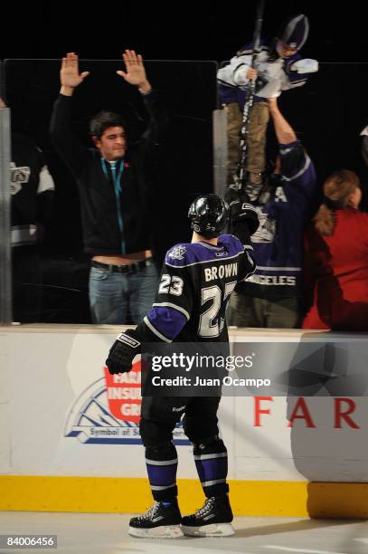 Dustin Brown of the Los Angeles Kings hand his stick to a fan after being named the star of the game for his first career hat trick during the game...