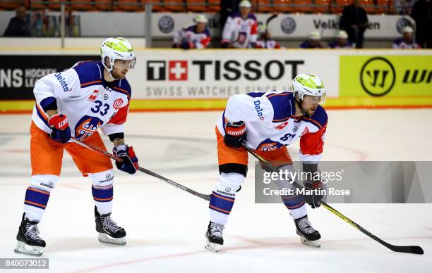 Veli Matti Vittasmaeki and Jukka Peltola of Tampere skate against the Grizzlys Wolfsburg during the Champions Hockey League match between Grizzlys...