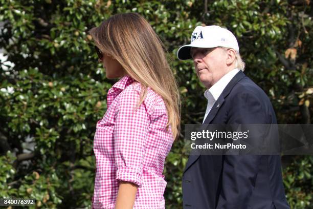 President Donald Trump, and First Lady Melania Trump, head in to the residence of The White House, after returning to the White House from a weekend...