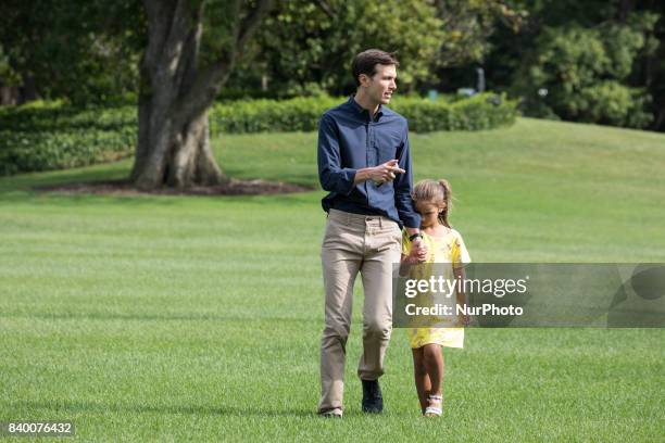 White House advisor Jared Kushner with his 6-year-old daughter Arabella, walk across the South Lawn, after returning to the White House from a...