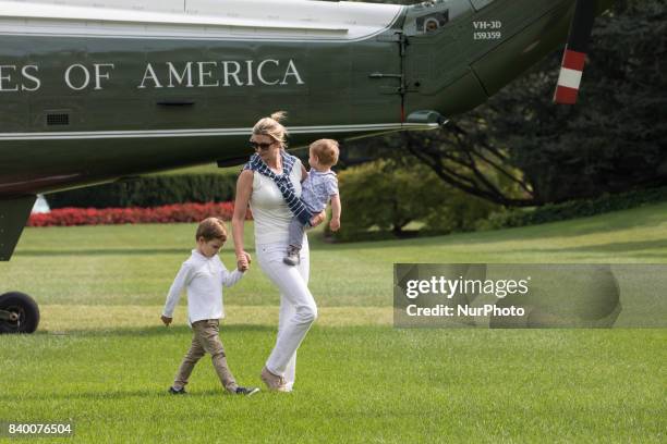 White House advisor Ivanka Trump with her sons, 3-year-old Joseph, and 1-year-old Theodore, walk across the South Lawn, after returning to the White...