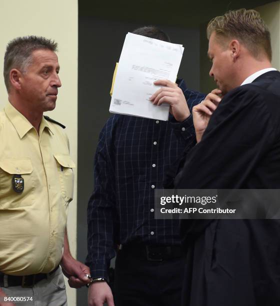 The defendant Philipp K. Arrives beside of his lawyer Sascha Marks in the court room at the country court in Munich, southern Germany, on August 28,...