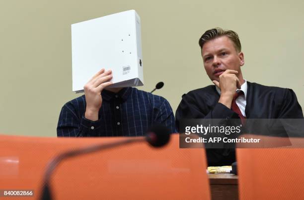 The defendant Philipp K. And his lawyer Sascha Marks wait in a court room at the country court in Munich, southern Germany, on August 28, 2017. One...