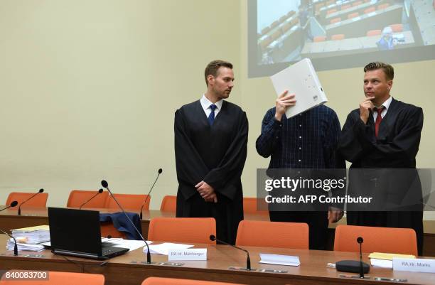 The defendant Philipp K. And his lawyers David Muehlberger and Sascha Marks wait in a court room at the country court in Munich, southern Germany, on...