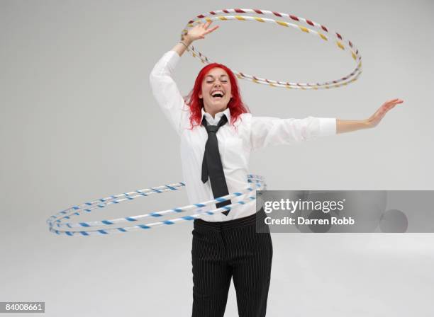 businesswoman performing with hoola hoops - hula hoop studio stock pictures, royalty-free photos & images