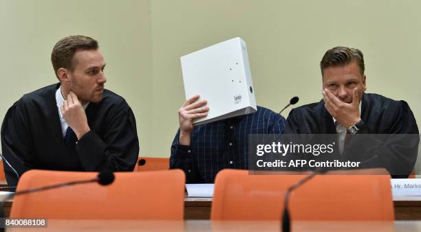 The defendant Philipp K. And his lawyers David Muehlberger and Sascha Marks wait in a court room at the country court in Munich, southern Germany, on...