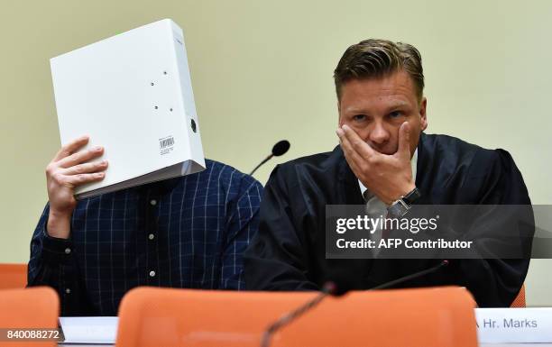 The defendant Philipp K. And his lawyer Sascha Marks wait in a court room at the country court in Munich, southern Germany, on August 28, 2017. One...
