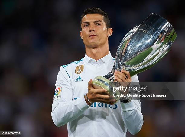 Cristiano Ronaldo of Real Madrid holds up the UEFA Super Cup trophy prior to the La Liga match between Real Madrid and Valencia at Estadio Santiago...