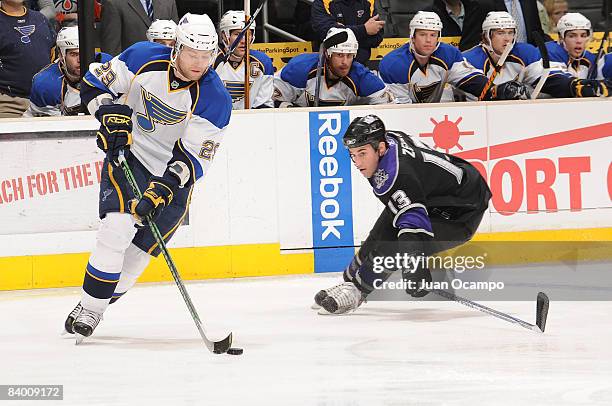 Jeff Woywitka of the St. Louis Blues drives the puck against John Zeiler of the Los Angeles Kings during the game on December 11, 2008 at Staples...