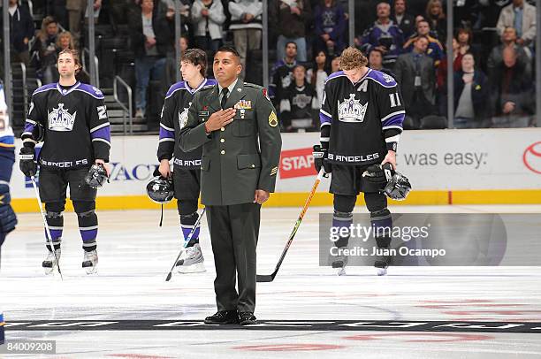 Army Staff Sgt. William Urias is honored during the singing of the National Anthem prior to a game between the St. Louis Blues and the Los Angeles...