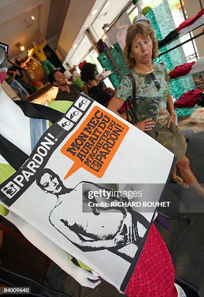 Customer looks on December 12, 2008 in Saint-Denis-de-la-Reunion on the French Indian ocean island of La Reunion at a bag showing a 1993 picture of...