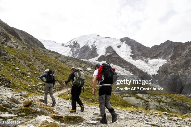 Alpinists walk on the "voie royale" route to climb atop the Mont-Blanc peak, after taking the Mont-Blanc Tramway at the highest station "Le nid...