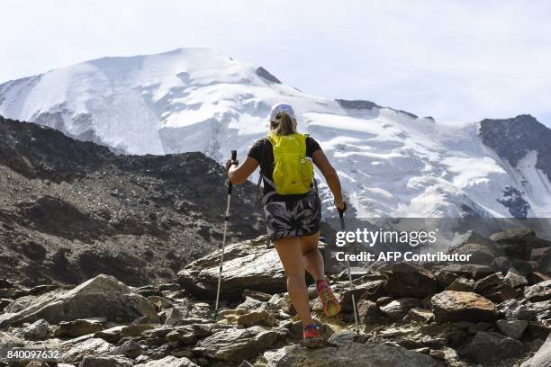 Woman walks in the famous "Couloir du Goûter" on the "voie royale" route to climb atop the Mont-Blanc peak on August 27, 2017 in the Mont-Blanc range...