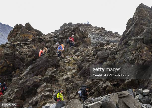 Climbers walk in the famous "Couloir du Goûter" on the "voie royale" route to climb atop the Mont-Blanc peak on August 27, 2017 in the Mont-Blanc...