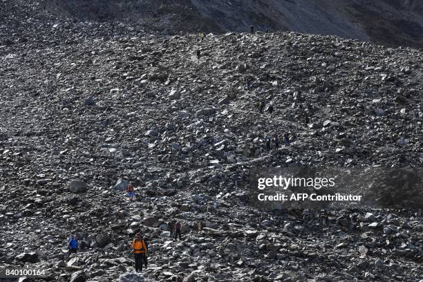 Climbers walk on the "voie royale" route to climb atop the Mont-Blanc peak, via the "couloir du Goûter" on August 27, 2017 in the Mont-Blanc range...