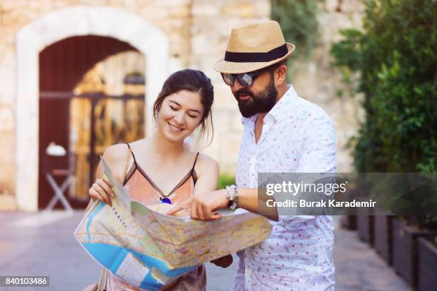 happy tourists couple holding map - city map with points of interest stock pictures, royalty-free photos & images