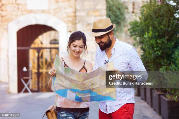 happy tourists couple holding map - city map with points of interest stock pictures, royalty-free photos & images