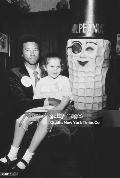 American tennis champion Arthur Ashe with Kristin Behrman, New York State's Easter Seal Child, 15th March 1977. The Easter Seals agency provides...