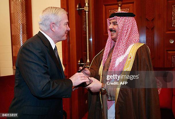 Defense Secretary Robert Gates presents a bronze eagle statue to Hamad bin Isa Al Khalifa king of Bahrain during a visit to Safryia Palace on...