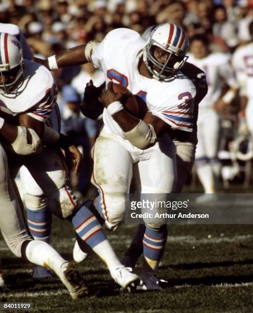 Hall of Fame running back Earl Campbell of the Houston Oilers carries the ball and looks for room to run during a 27-7 loss to the Oakland Raiders in...