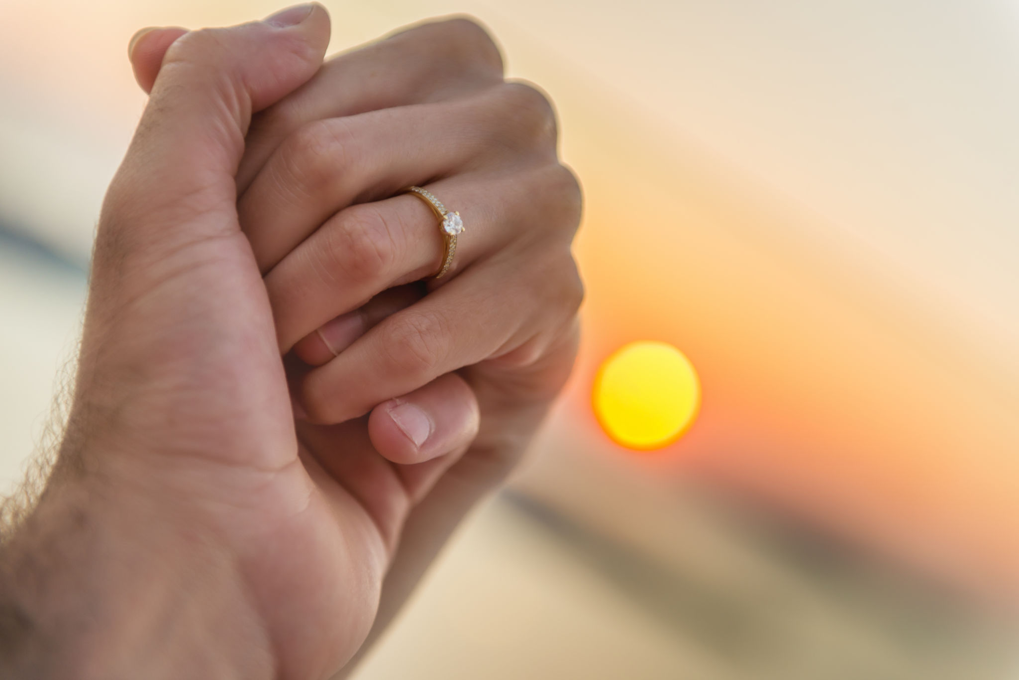 Couple holding hands during sunset Couple holding hands during sunset