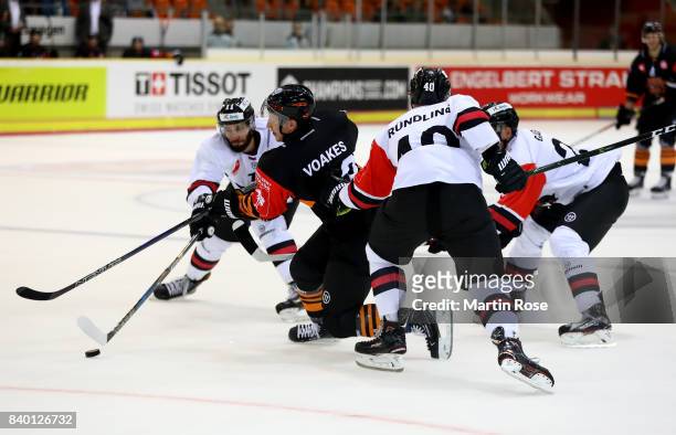 Mark Voakes of Wolfsburg and Vladimir Mihalik of Bystrica battle for the puck during the Champions Hockey League match between Grizzlys Wolfsburg and...