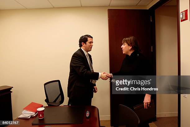 Paul Costiglio, a marketing and public relations professional , shakes hands with recruiter Julie Jarrett of the executive search firm Heyman...