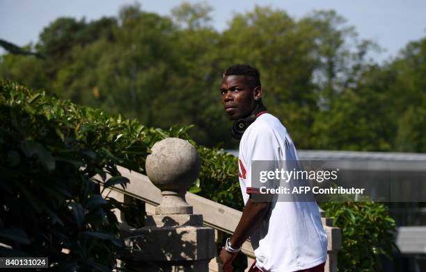 France's midfielder Paul Pogba arrives at the French national football team training base in Clairefontaine on August 28 as part of the team's...