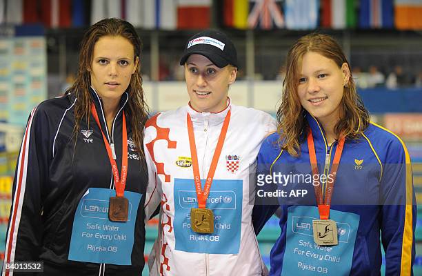 Sanja Jovanovic of Croatia celebrates her gold medal after winning at women�s 100m backstroke race, next to the second placed Kateryna Zubkova of...