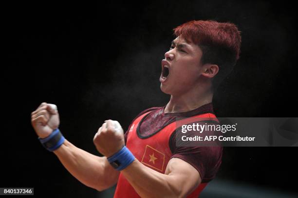 Vietnam's Trinh Van Vinh celebrates after winning the men's weightlifting 62kg final of the 29th Southeast Asian Games in Kuala Lumpur on August 28,...