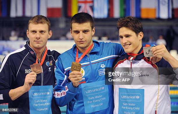 Stanislav Donets of Russia celebrates his gold medal after winning at men�s final 50m backstroke race, next to the second placed Aschwin Wildeboer...