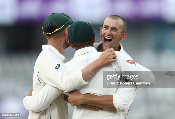 Ashton Agar of Australia celebrates with Usman Khawaja of Australia after he took a catch to dismiss Soumya Sarker of Bangladesh during day two of...